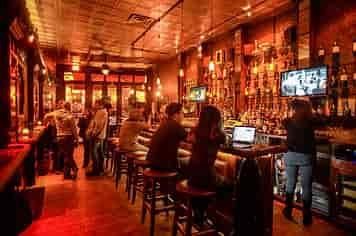Vibrant Velvet Brooklyn bar with rustic decor, ideal for networking events and gatherings.