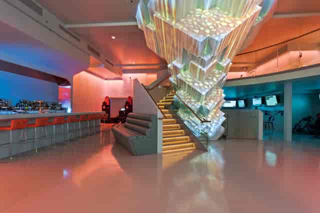 Modern event space in VR World NYC with sleek bar and dynamic lighting for corporate gatherings.