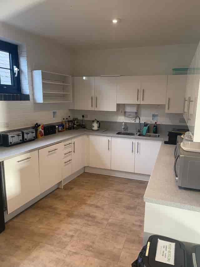 Modern kitchen in HQ1, featuring white cabinetry for event catering and refreshments.