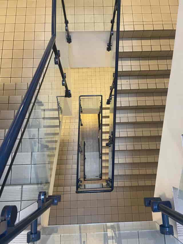 Well-maintained staircase with glass railings, ideal for events and gatherings.