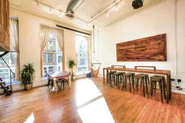 Bright event space with large windows, ideal for meetings and social gatherings.