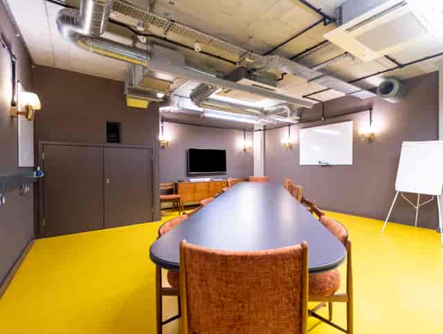 Modern meeting room with long table, ideal for collaboration and presentations.