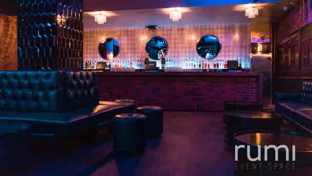 Stylish event space with sleek bar, ideal for cocktail receptions and gatherings.
