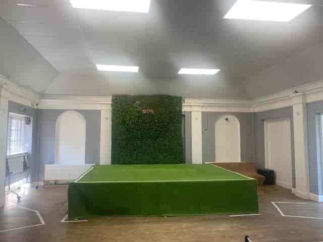 Banquet Hall in The Garden of Lewisham with raised stage, ideal for events and workshops.