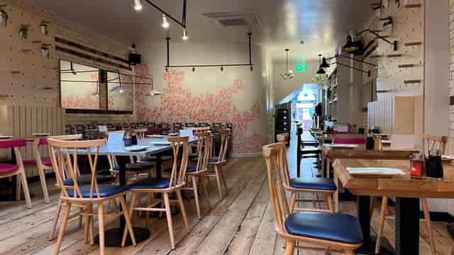 Ramen Bar Brighton: cozy dining space with wooden tables, perfect for casual events.