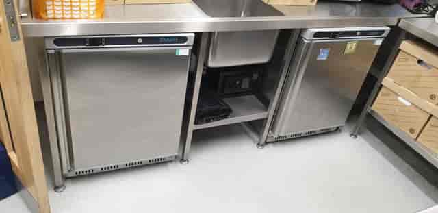 Eden Cafe Kitchen Hire: sleek stainless steel kitchen with under-counter fridges for events.