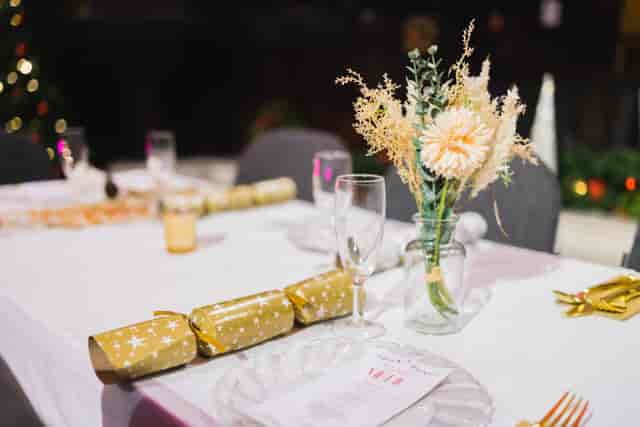 Elegant table setting with floral centerpiece for holiday gatherings at St Edmund the King.