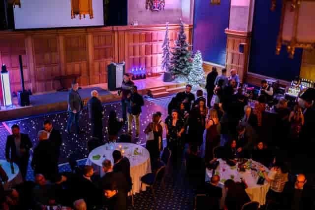 Vibrant Great Hall event space with Christmas tree for festive networking celebration.