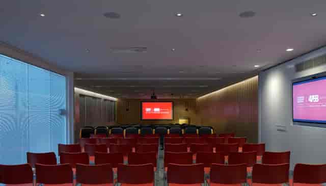 Modern conference room with red chairs for presentations at Auditorium, Bastwick St.