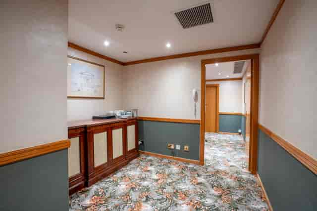 Gloucester Boardroom corridor with wood accents, ideal for professional meetings and events.
