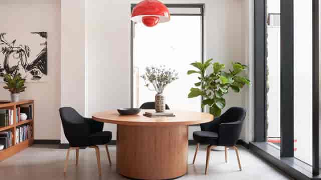 Modern meeting space with round table and black chairs at WeWork 1701, D.C.