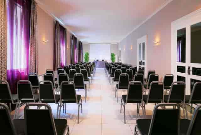 Meeting space at Sheraton Diana Majestic, Milan with black chairs for conferences.