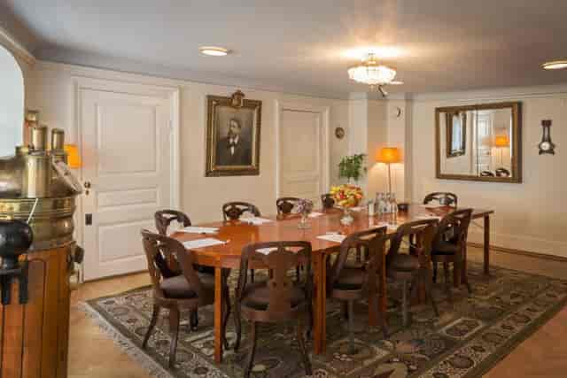 Elegant meeting room with wooden table, ideal for conferences in Stockholm.