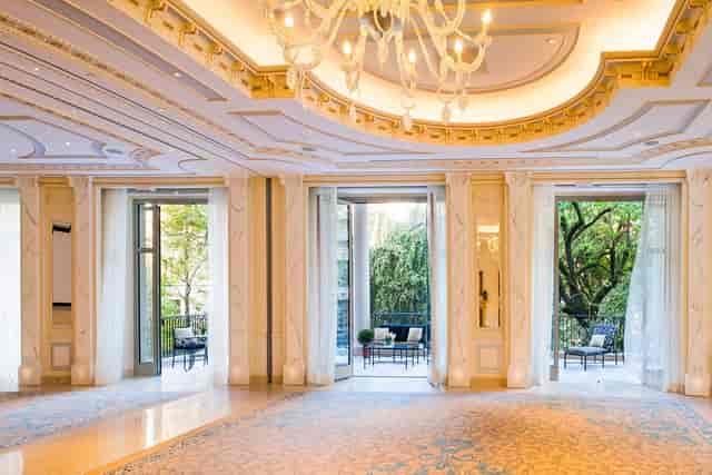 Elegant event space in Palazzo Parigi, Milan with chandelier and natural light.