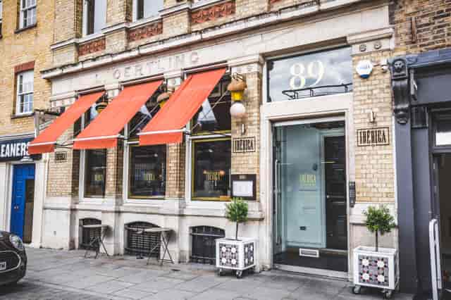 Stylish bar area with orange awnings, ideal for networking events and private functions.