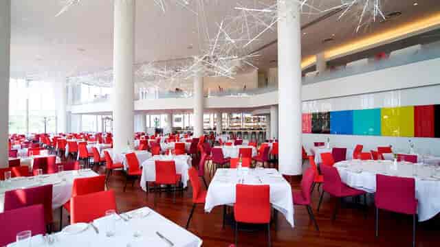 Modern Sequoia dining room with vibrant chairs, ideal for corporate events and private parties.