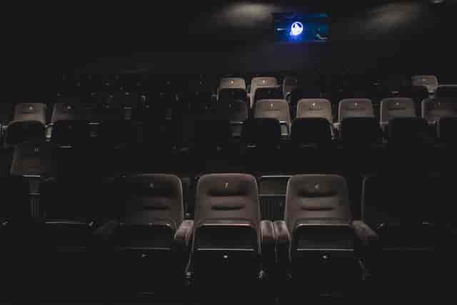 Dark auditorium with plush seating, ideal for film screenings and presentations.