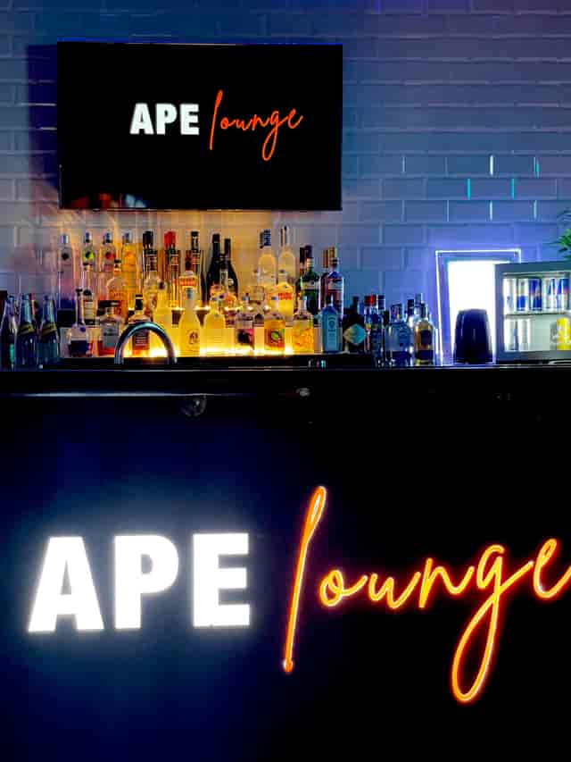 Cocktail bar setup with illuminated bottles for networking events and social gatherings.