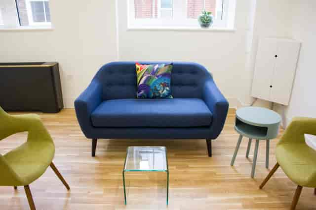 Modern lounge with blue sofa, ideal for networking events and informal meetings.