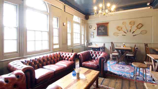 Cozy Blue Room at St Aldates Tavern with leather sofas, ideal for meetings and gatherings.