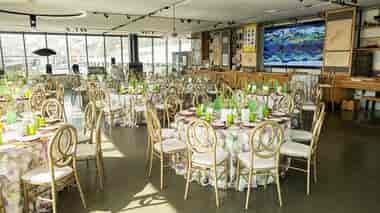 Elegant event space with floral tables and gold chairs for a stylish banquet in San Francisco.