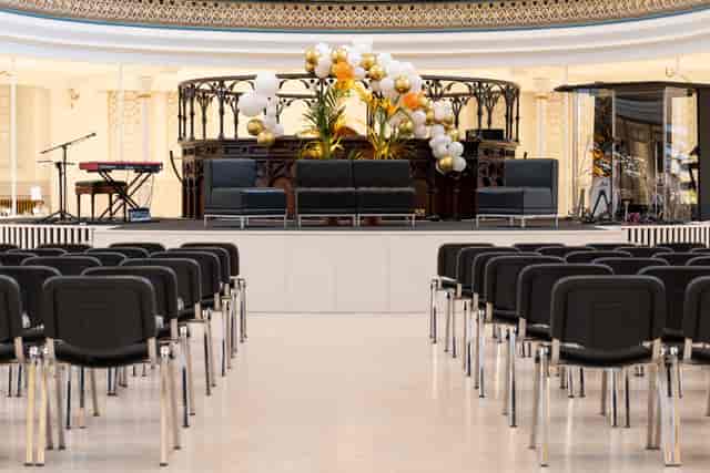 Elegant auditorium stage with decor for a professional panel discussion event.