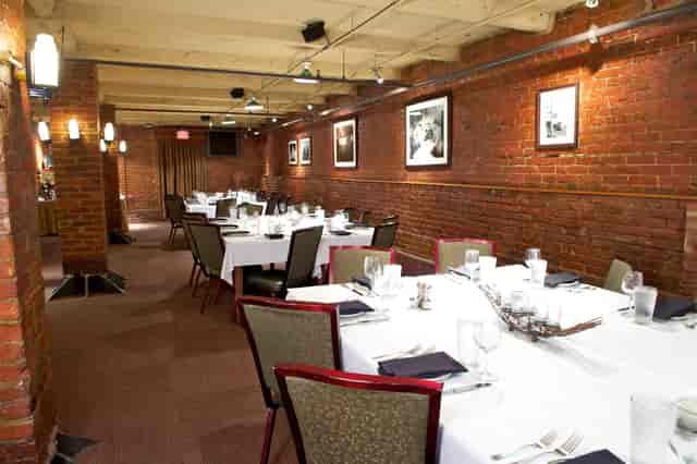 Brewer's Lounge dining space with warm brick walls, ideal for corporate events and gatherings.