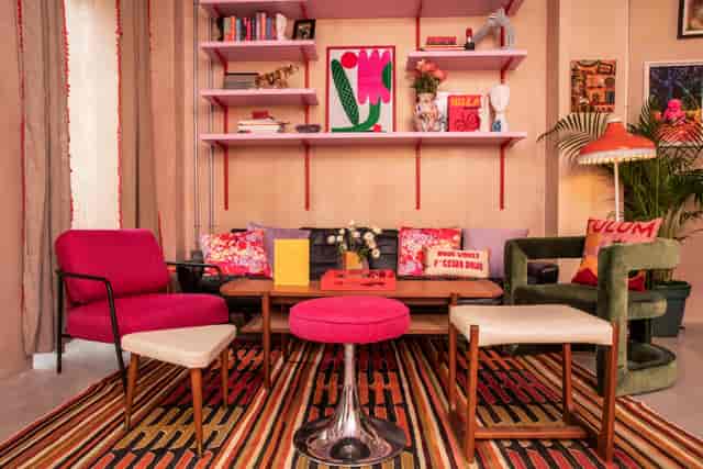 Open plan living room with colorful chairs, ideal for networking events and informal meetings.