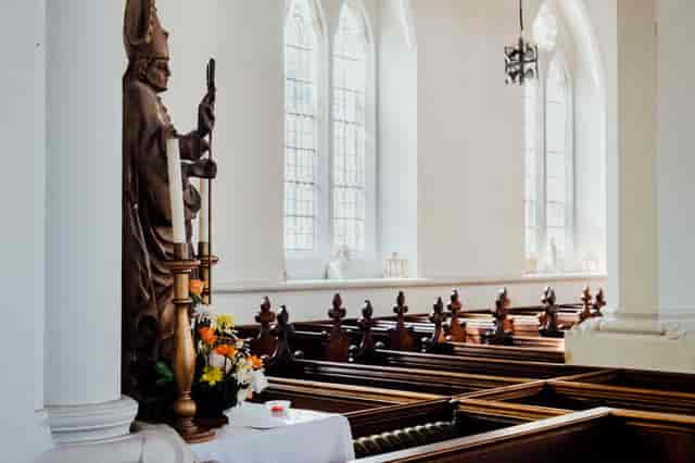 St Giles Church interior with stained glass, perfect for weddings and memorials.