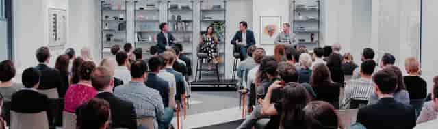 "Panel discussion at Grand Central Lounge with engaged audience and modern decor."