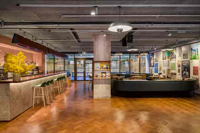 Modern event space at Toklas Restaurant with stylish bar and natural light.