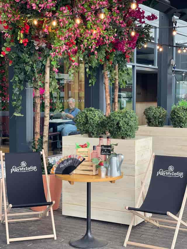 Tapas Revolution outdoor event space with lush greenery, ideal for gatherings and networking.