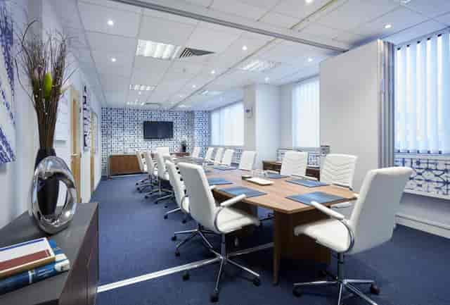 Modern conference room with large table, ideal for corporate meetings and presentations.