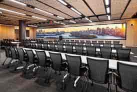 Modern conference room at Bryant Forum with skyline view, ideal for meetings and workshops.