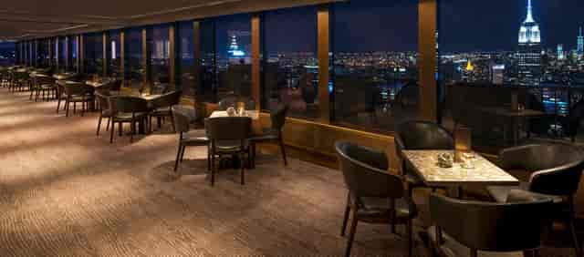 Rainbow Room dining space with elegant tables, perfect for upscale events and gatherings.