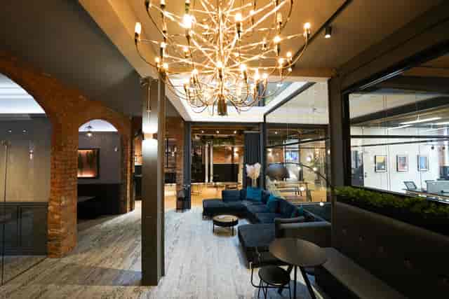 Modern meeting room with chandelier, ideal for events and networking.