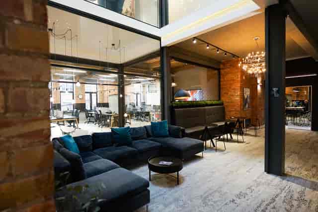 Modern meeting room with cozy seating for events and networking in Colony Jactin House.