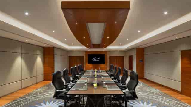 Modern conference room with sleek table setup at Kempinski Hotel for meetings and presentations.