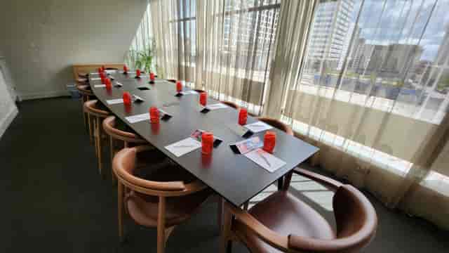 Corporate meeting space with long table, vibrant decor, in Unique Venues Birmingham.