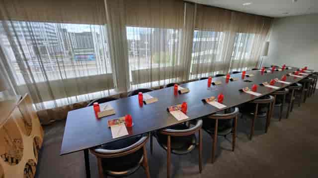 Meeting room at Unique Venues Birmingham with red accents for professional events.