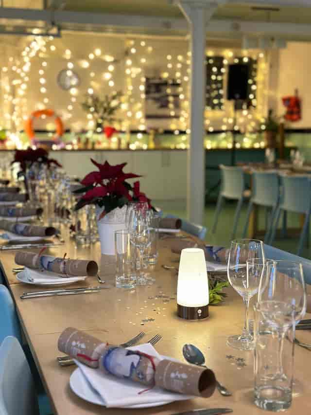 Elegant dining table with poinsettias at Wallacespace St Pancras for corporate events.