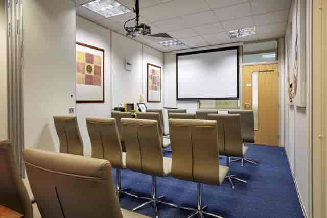 "Modern meeting room with projection screen for presentations at Catalyst House."