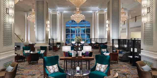 Elegant Bras Basah Room lobby with chandeliers, ideal for networking events and meetings.