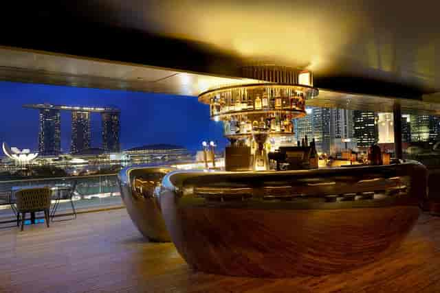 Sophisticated bar with city skyline, perfect for upscale events in Singapore.