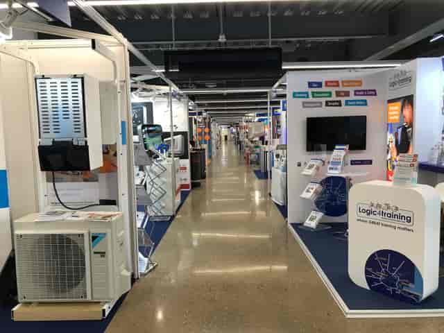 Tottenham Hotspur Stadium exhibition hall with vendor booths for networking event.