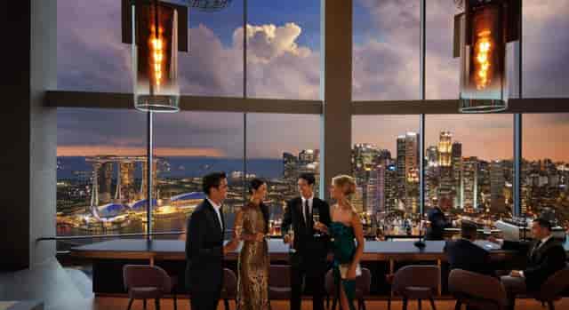 Sophisticated networking event at Skai Restaurant with city skyline backdrop.