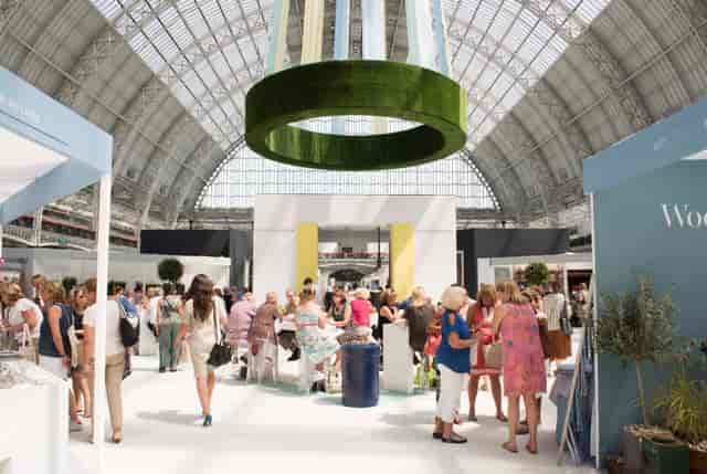 Grand Hall Olympia bustling with attendees at a vibrant trade show event.