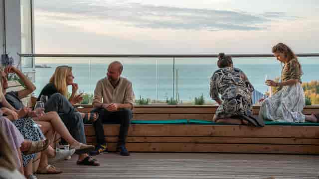 Outdoor networking venue with scenic water backdrop for casual meetings.