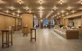 Elegant event venue with natural light and wooden accents in Andaz Singapore.