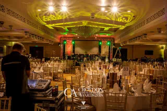 Elegant Grand Ballroom set for an awards ceremony with ambient lighting and stage.